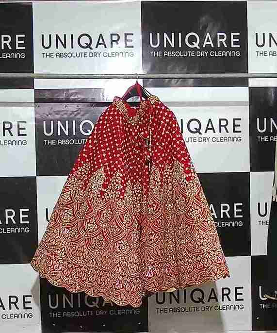 Bridal lehenga on Uniqare branded backdrop in Gurgaon