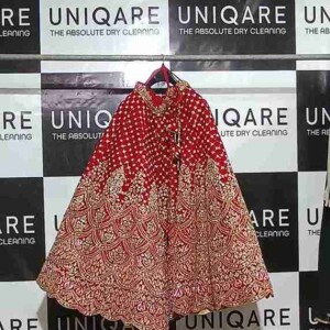 Precision in every press – Wrinkle-free, crisp results by Uniqare Dry Clean’s garment care professionals. A professional dry cleaning expert pressing and steaming clothes at Uniqare Dry Clean in Gurgaon