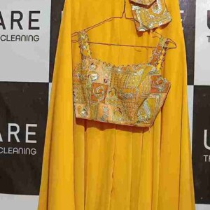 From inspection to sorting – every garment is handled with precision at Uniqare Dry Clean. A professional cleaner inspecting and sorting clothes before the dry cleaning process